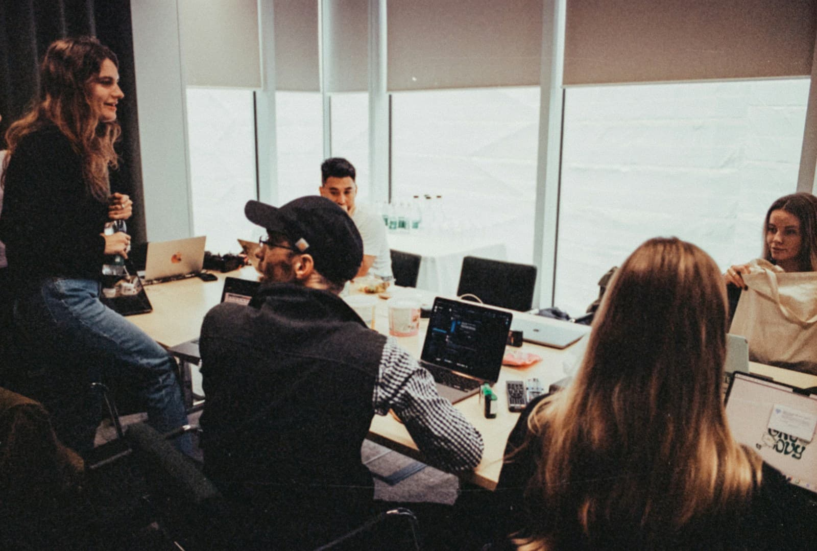 Colleagues discussing a project around a shared table